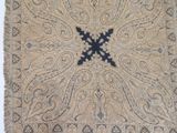 an old rug with a black cross on it