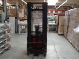 a fork lift truck in a warehouse with pallets and boxes