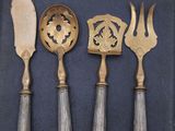 four different types of silverware on a blue tray