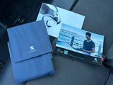 a blue bag sitting on the seat of a car with a picture of a man on it