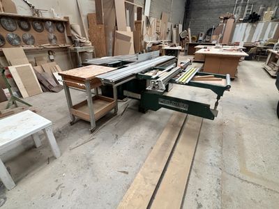 several pieces of wood are stacked on a table in a workshop