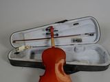 an image of a violin in a case on a white surface