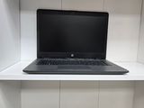 a laptop computer sitting on top of a white shelf