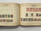 an open book with a lot of stamps on it sitting on a table