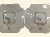 two white plates with a picture of a couple of people on them