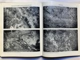 a book opened to show pictures of a mountain range