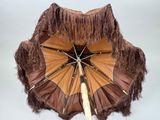 un parapluie marron orné de franges sur le dessus