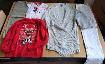 a box of clothes and a sweater on a table