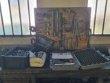 a workbench with many tools on it in a room