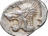 a close up of a silver coin with a dragon on it