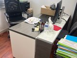 a desk with a chair and a computer on it