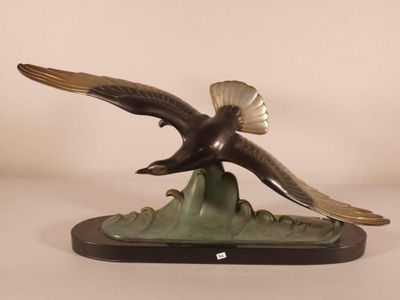 statue of an eagle flying over a mountain on a white background