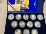 a box of silver coins with a picture of a man and a woman