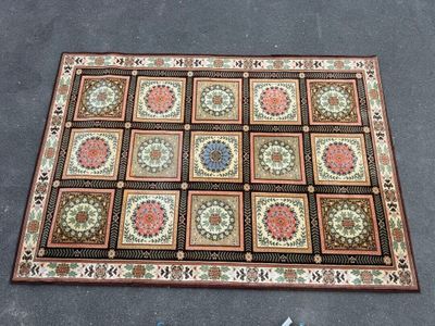 a rug that is laying on the ground next to a pair of scissors