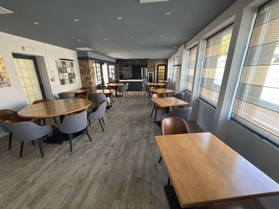 many tables and chairs in this empty restaurant