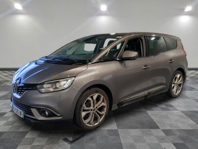 a grey car parked on a checkered floor in a garage