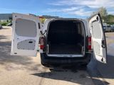 a white van with its doors open in a parking lot
