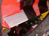a close up of a red machine with a label on it