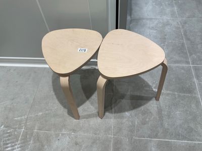 two small wooden tables sitting on a tiled floor