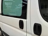 a white van parked in a parking lot next to a building
