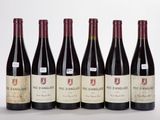 six bottles of red wine are lined up in a row