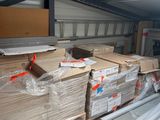 a lot of boxes and pallets in a storage room