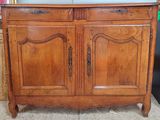 a wooden cabinet with a mirror on top of it