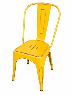 the yellow chair is sitting on a white surface