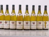 six bottles of wine are lined up in a row on a table