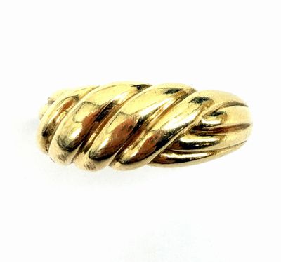 a close up of a gold ring on a white background