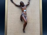 a close up of a framed picture of jesus on a cross