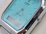 a silver wrist watch with a blue face on display