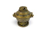 an image of a gold and black urn with a lion on top