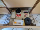 an image of a kitchen cabinet with a pot and pan in it