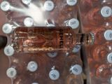 a bottle that is sitting on top of a pile of bottles