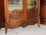 a large wooden cabinet with a mirror on top of it