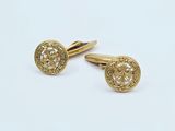 two pairs of gold cufflinks on a white background