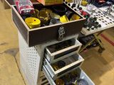 a workbench with a drawer full of tools in it