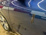 a close up of a car door handle with a sticker on it