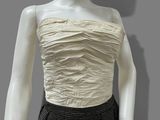 a mannequin wearing a white top and black skirt
