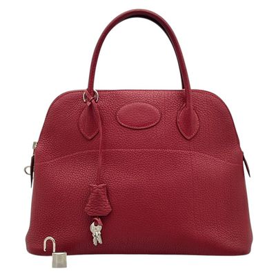 a red leather handbag with a lock on the handle