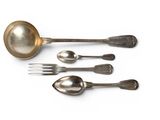four spoons and a fork on a white surface