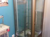 a glass display case in the corner of a room