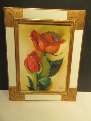 painting of two red roses in a gold frame on a white surface