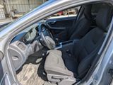the interior of a car with the door open and the driver ' s seat down