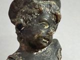 a statue of a boy with a hat on it ' s head