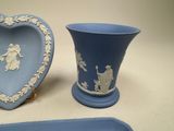 two blue vases and a tray with a picture of a man and woman on them