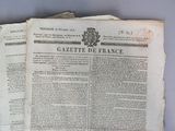 three pages of old french newspaper sitting on top of each other