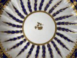 two plates with blue and white designs on them on a table