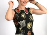 a woman that is posing for a picture in a dress